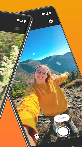 Simple Camera outdoor selfie capture with mountain backdrop, demonstrating front-facing camera and photo button